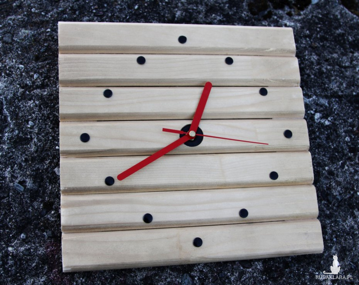Niebanalny drewniany zegar ścienny z czerwonymi wskazówkami
